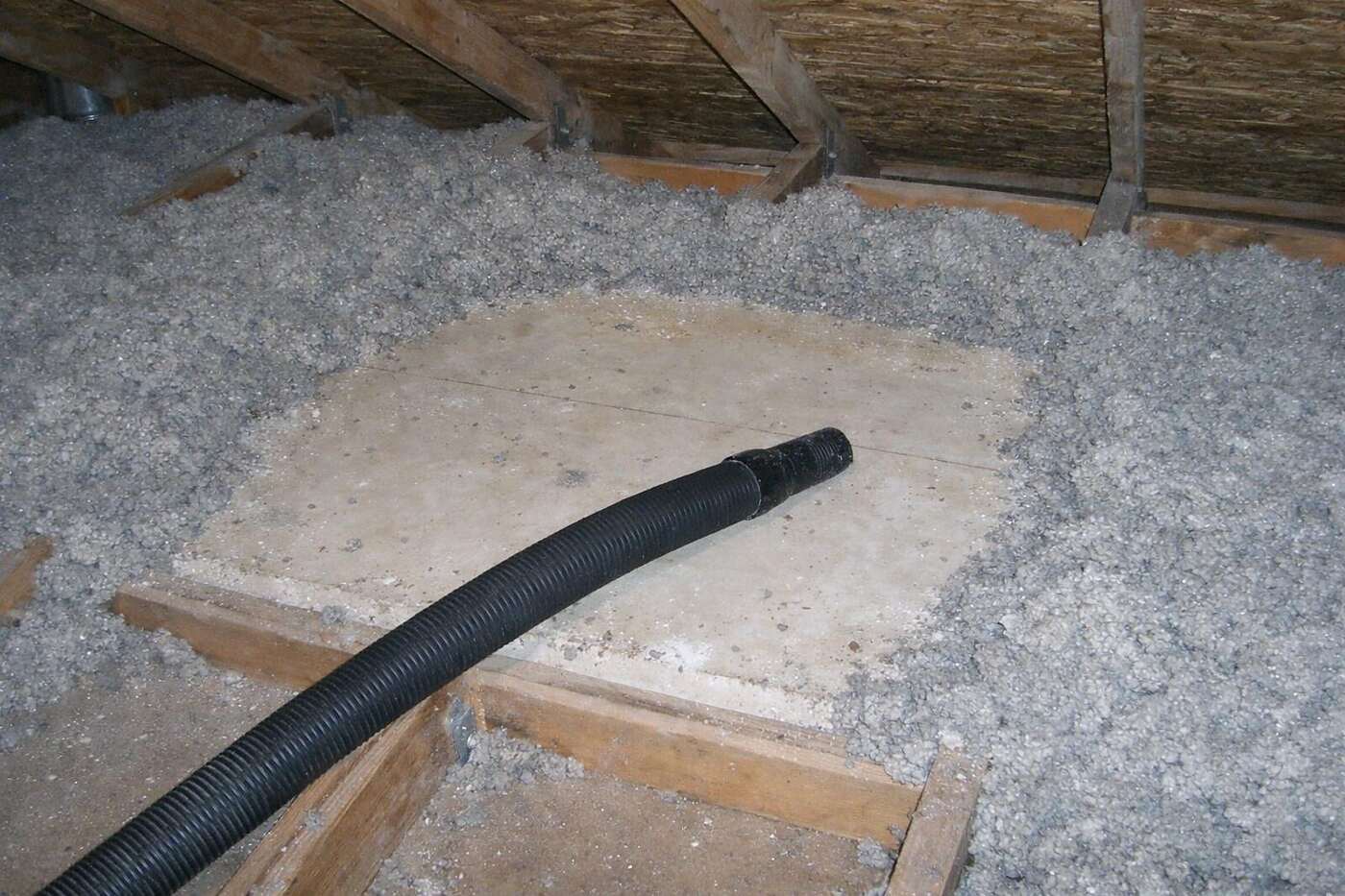 Compressed insulation pulled back from the drywall in a Phoenix attic