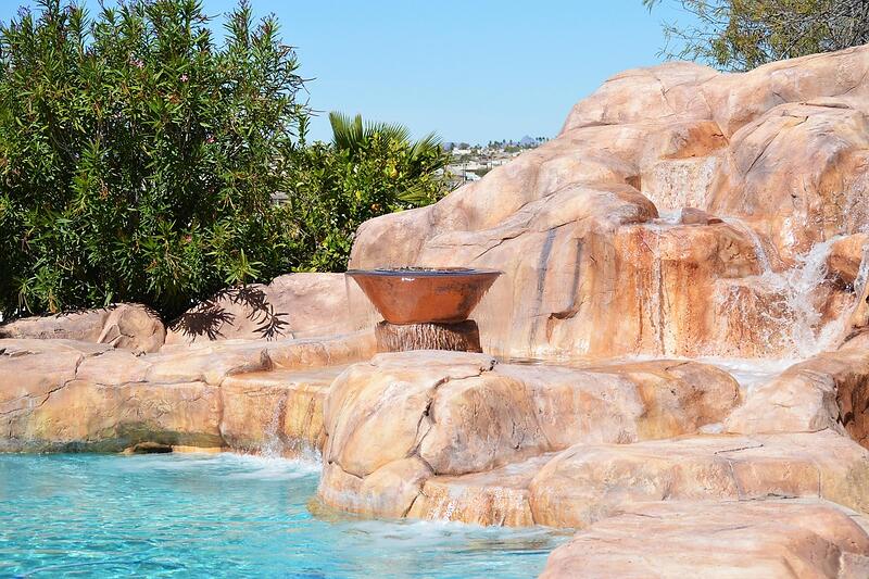 A backyard pool with rock landscaping on a large Valley lot