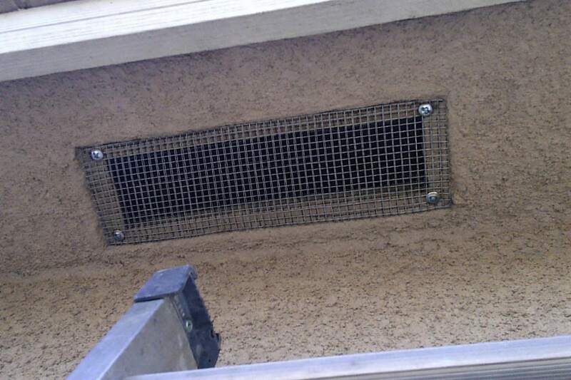 Quarter-inch galvanized hardware cloth fitted behind a soffit vent and screwed to the frame